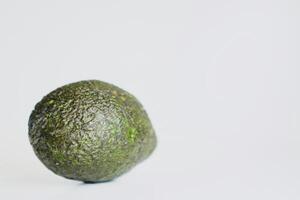 a green avocado on a white background photo