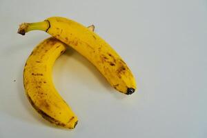 yellow banana on a white table photo