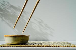 chopsticks and bowl of soy sauce photo