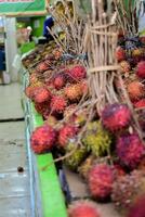 Groups of rambutan fruits displayed in supermarket box photo