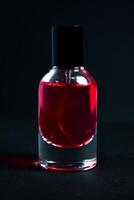 Transparent Red Bottle Perfume isolated black background for mock up design photo