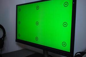 Green screen with tracking, graphic designer set up working on table photo