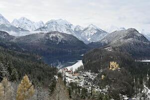 Alpsee in the bavarian alps with a castle in a distance photo