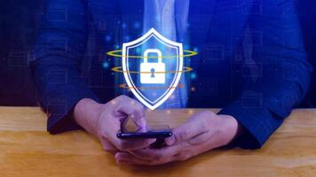 Computer network protection, secure and safe your data concept, businessman holding shield protection icon on smartphone, Security shield Lock Security Business Protect Concept. photo