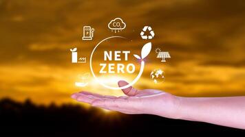 Net Zero and Carbon Neutral Concepts, Net zero greenhouse gas emissions target, Climate neutral long strategy, Businessman holding NetZero icon. photo