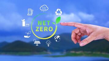 Net Zero and Carbon Neutral Concepts, Net zero greenhouse gas emissions target, Climate neutral long strategy, Businessman holding NetZero icon. photo