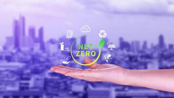 Net Zero and Carbon Neutral Concepts, Net zero greenhouse gas emissions target, Climate neutral long strategy, Businessman holding NetZero icon. photo