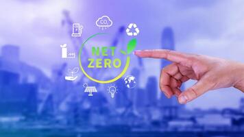 Net Zero and Carbon Neutral Concepts, Net zero greenhouse gas emissions target, Climate neutral long strategy, Businessman holding NetZero icon. photo