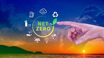 Net Zero and Carbon Neutral Concepts, Net zero greenhouse gas emissions target, Climate neutral long strategy, Businessman holding NetZero icon. photo