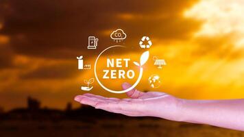 Net Zero and Carbon Neutral Concepts, Net zero greenhouse gas emissions target, Climate neutral long strategy, Businessman holding NetZero icon. photo