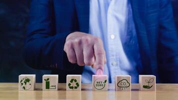 Net Zero and Carbon Neutral Concepts, Net zero greenhouse gas emissions target, Climate neutral long strategy. Wooden cubes with NetZero icon. photo