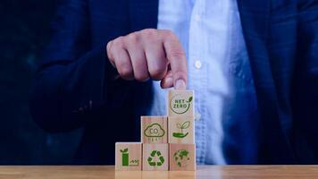 Net Zero and Carbon Neutral Concepts, Net zero greenhouse gas emissions target, Climate neutral long strategy. Wooden cubes with NetZero icon. photo