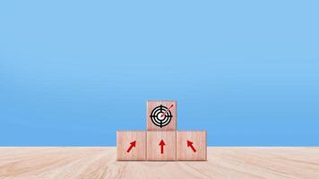 Target concept, objective, virtual target board and rising arrows screen printed on wooden cubes. set goals for business success. photo