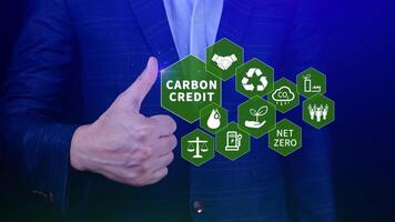 Green energy, Carbon credit market concept, Businessman holding Carbon credit icon, Net zero, Green energy icon. Carbon Neutral in industry Net zero emission eco energy. photo