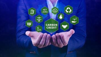 Green energy, Carbon credit market concept, Businessman holding Carbon credit icon, Net zero, Green energy icon. Carbon Neutral in industry Net zero emission eco energy. photo