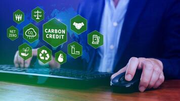 Green energy, Carbon credit market concept, Businessman holding Carbon credit icon, Net zero, Green energy icon. Carbon Neutral in industry Net zero emission eco energy. photo