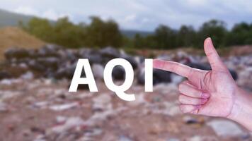 AQI, Abbreviation of air quality index, hand holding AQI on nature background, environment concept. photo