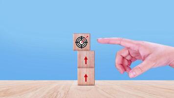 Hands place virtual target board and arrows on wooden block, Business success goals and objective goal concept, Achieving goals and objectives or goal setting concept. photo