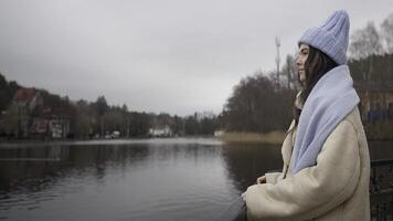 Girl near the pond. Beautiful girl in the autumn park video