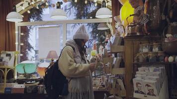 girl looking at a postcard in a souvenir shop video