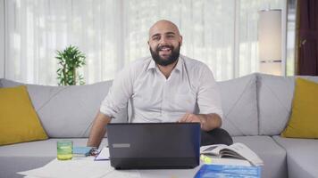 Home office worker man looking smugly at camera. video