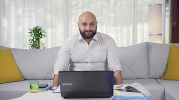 Home office worker man looking at camera with excitement and feeling happy. video