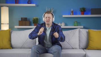 Happy man listening to music with headphones. video