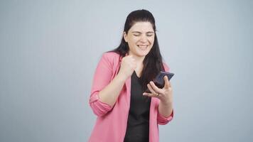 Business woman dancing with phone in hand. video