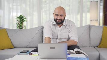 Home office worker man looking with satisfied expression. video