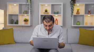 Man looking at laptop in amazement. video