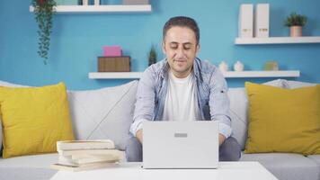 Man working on laptop with happy expression. video