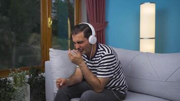 Unhappy man listening to music with headphones. video