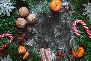 Christmas card. Tangerines, nuts, spruce, candy photo