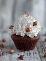 Delicious chocolate brownie muffins with nuts and whipped cream photo