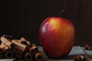 Red apple, anise and vanilla on the table photo