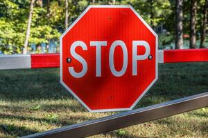 Red stop sign on a gate photo