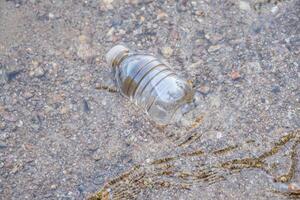 el plastico botella flotante en el lago foto