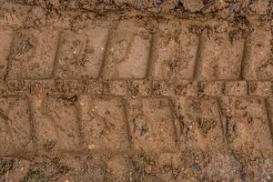 Bulldozer tracks in the mud closeup photo