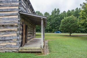 Rustic cabin with vintage car photo