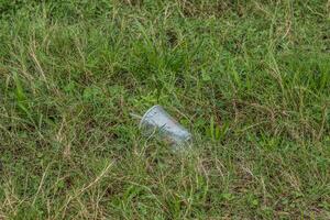 Plastic cup laying on the ground photo