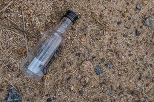 Liquor bottle on the ground photo