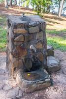 Old stone drinking fountain closeup photo