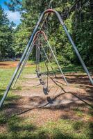 Playground swing set at the park photo