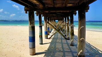 Old wooden pier on Prison Island Tanzania. Photographed from below. photo