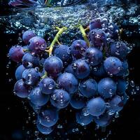 Grapes falling in water with splash on black background. photo
