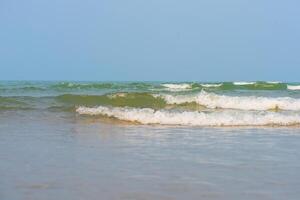 Blue sea waves on the surface ripples blurred. Defocus blurred transparent blue colored clear calm water surface texture with splash and bubbles. Water waves with shining pattern texture background. photo