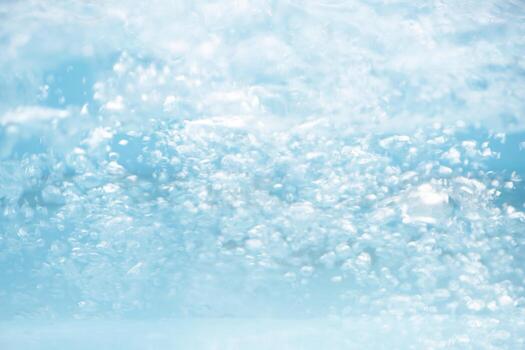 Bluewater waves on the surface ripples blurred. Defocus blurred transparent blue colored clear calm water surface texture with splash and bubbles. Water waves with shining pattern texture background. photo