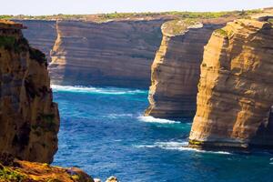 Seaside Majesty Breathtaking Coastal Cliffs Meet Stunning Blue Sea, A Spectacle of Nature's Grandeur photo