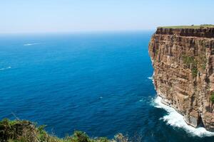 Seaside Majesty Breathtaking Coastal Cliffs Meet Stunning Blue Sea, A Spectacle of Nature's Grandeur photo