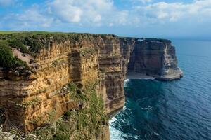 Seaside Majesty Breathtaking Coastal Cliffs Meet Stunning Blue Sea, A Spectacle of Nature's Grandeur photo